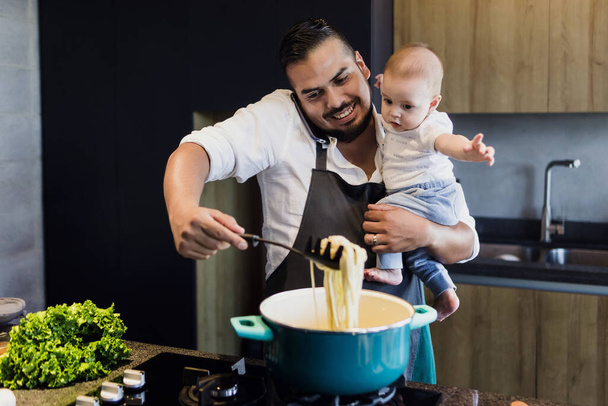 latin single father and baby son cooking at kitchen in Mexico Latin America, hispanic young family - Photo, Image