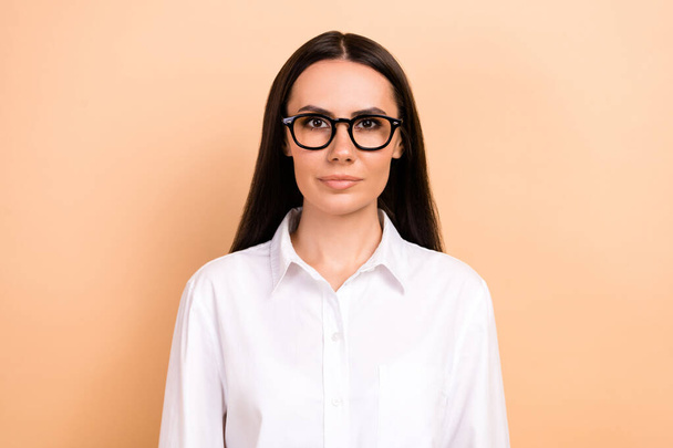 Portrait of confident serious face entrepreneur business lady wear formal white shirt new glasses boss isolated on beige color background. - 写真・画像