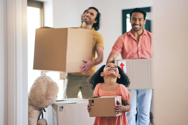 Happy, family and box moving with child and gay parents in new home with cardboard package. Smile, kid and lgbt people together with real estate and property mortgage in a house helping father. - Photo, Image