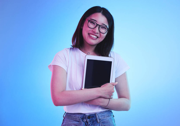 Young woman, student and tablet mockup for online education, e learning or study on blue, studio background. Asian person with digital technology, marketing space and university information on screen. - Photo, Image