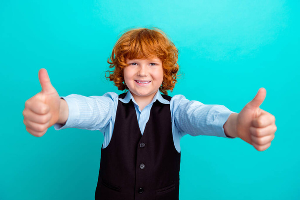 Photo portrait of charming curly redhead boy show double thumb up wear trendy school garment isolated on aquamarine color background. - Foto, immagini