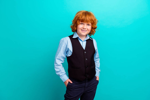 Photo portrait of adorable foxy wavy hair boy hands pockets posing wear trendy school outfit isolated on aquamarine color background. - Foto, Imagem