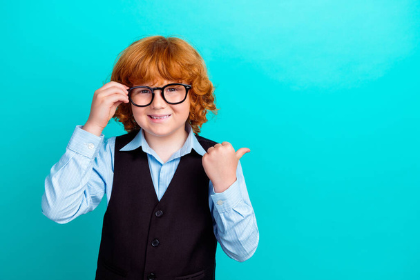 Photo of intelligent cute little boy arm touch eyeglasses direct thumb finger empty space ad isolated on teal color background. - Fotoğraf, Görsel