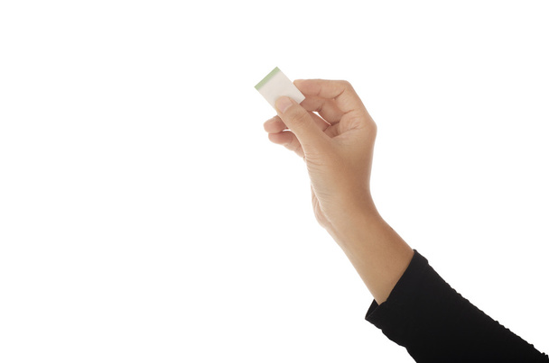 Mujer mano sosteniendo goma de borrar aislado en blanco
 - Foto, imagen
