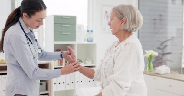 Woman, doctor and senior patient in consultation for checkup, appointment or exam at hospital. Female person or medical professional checking elderly customer in care, support or trust at the clinic. - Filmmaterial, Video