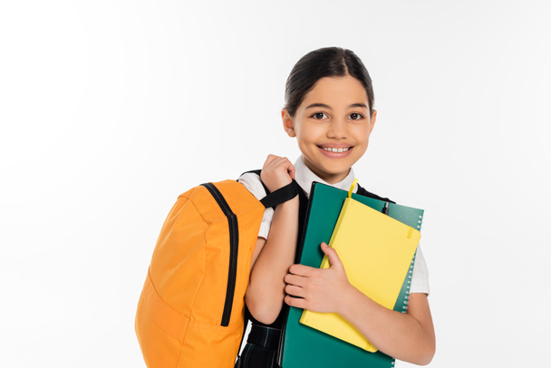 happy schoolgirl standing with notebooks in and backpack in hands, new school year concept, student - Fotografie, Obrázek