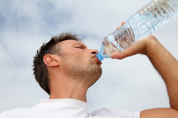 Man drinking water from bottle - Photo, Image