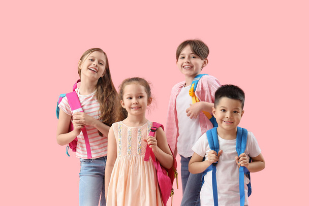 Pienet oppilaat, joilla on reput vaaleanpunaisella taustalla - Valokuva, kuva
