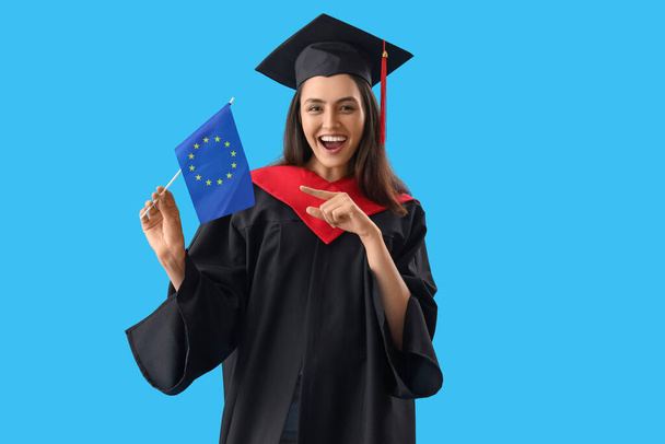 Female graduate student with flag of European Union on blue background - Foto, afbeelding
