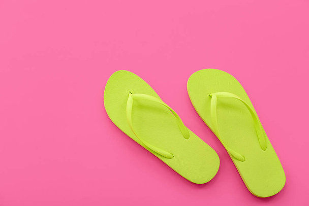 Pair of green flip flops on pink background - Photo, Image