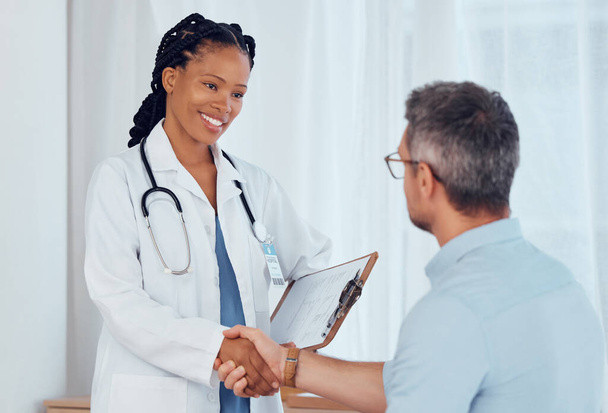 Doctor, patient and people shaking hands, smile and hospital checkup with healthy diagnosis, healthcare results or support. Clinic nurse, trust and surgeon welcome, thank you or hand shake for client. - Valokuva, kuva