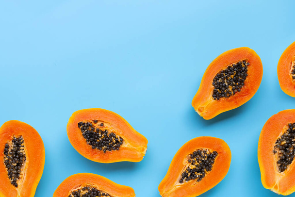 Papaya fruit on blue background. Top view - Photo, Image