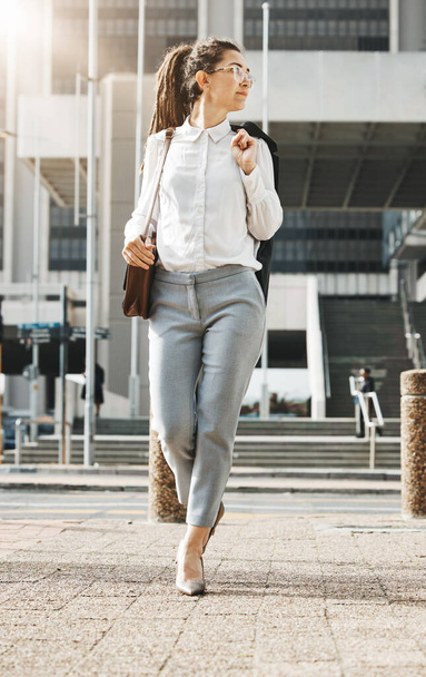 City, walking and business woman on a sidewalk with travel, commute and urban journey. Road, outdoor and female professional in the morning traveling for work, career and job in New York on street. - Photo, Image