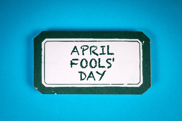 April Fools Day. Sticky note with text on a blue background. - Photo, Image