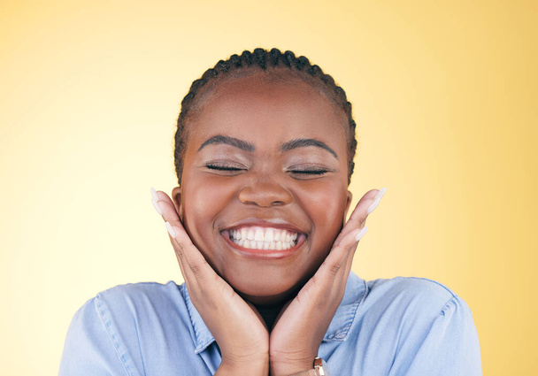 Happy face, hands of black woman and teeth in studio isolated on a yellow background. Smile, touch and dental wellness of natural African model in cosmetic facial treatment, beauty and skincare. - Foto, Imagen