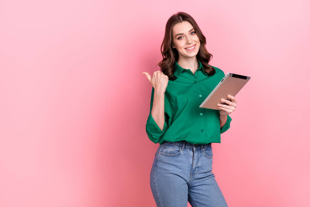 Photo of pretty shiny lady wear green shirt working modern gadget thumb empty space isolated pink color background. - 写真・画像
