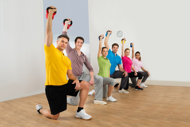 Friends Exercising With Kettle Bells - Фото, зображення