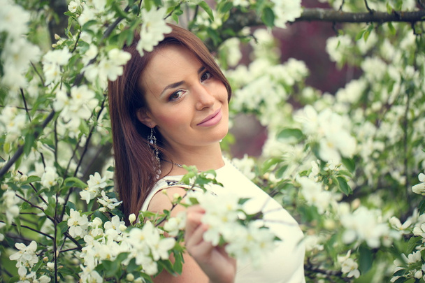 girl in flowers of apple tree - Photo, Image