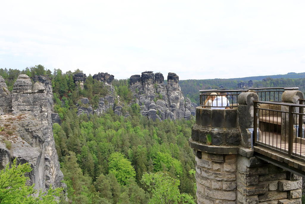 May 14 2023 - Rathen, Saxon Switzerland in Germany: people enjoy the Rock formations of the Elbe sandstone mountains around the Bastei bridge - Photo, Image