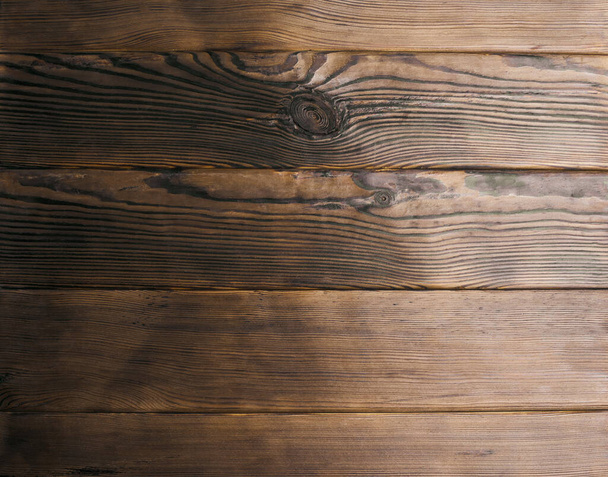 Tmavé dřevěné pozadí s uzly. Dřevěné desky s přirozenou strukturou. Prázdné hnědé dřevěné pozadí pro design - Fotografie, Obrázek
