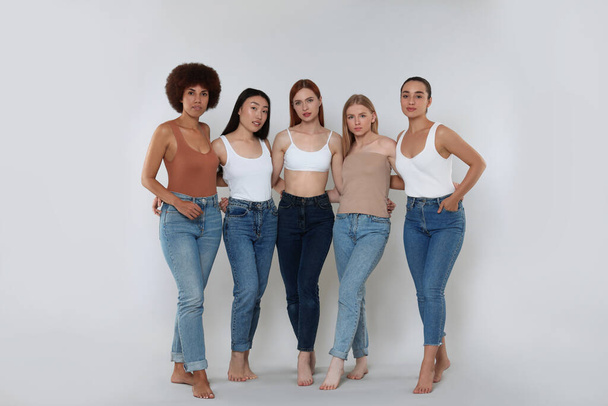 Group of beautiful young women on light grey background - Foto, immagini