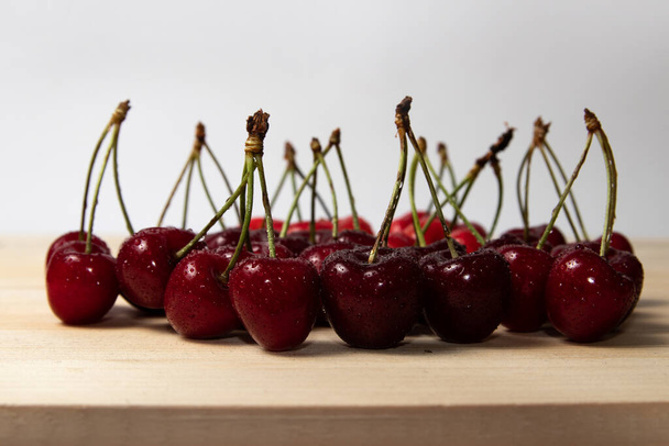 Fresh ripe cherries on a wooden board - Photo, Image
