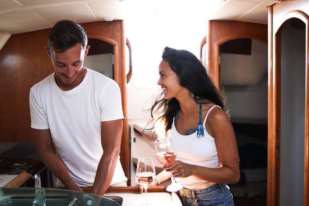 Photo of young couple inside a sailing boat - Φωτογραφία, εικόνα