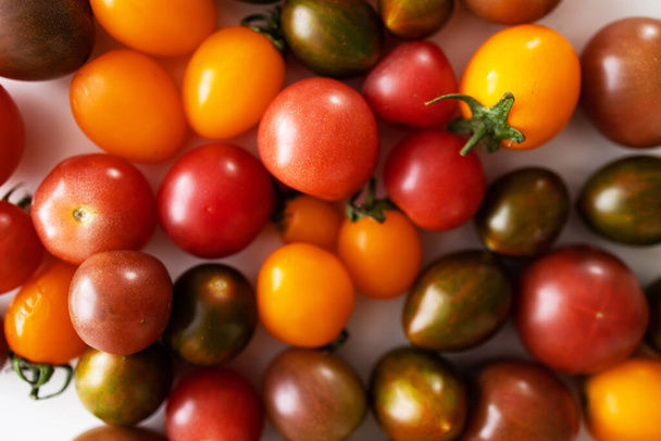 Colorful cherry tomatoes on white background. Close up. Selective focus. - Photo, Image