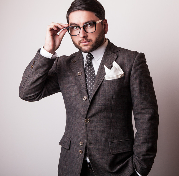 Elegant young handsome man in grey costume. Studio fashion portrait. - Photo, image