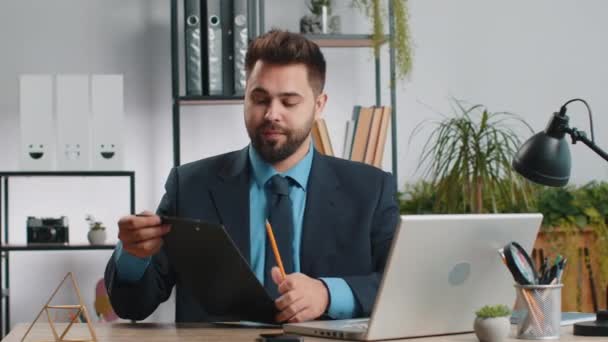 Bělošský podnikatel pracující na notebooku v domácí kanceláři mluvit na on-line komunikace video hovor se zaměstnancem, šéf. Manažer muž na volné noze podpůrné služby při pohledu na webkameru počítače - Záběry, video