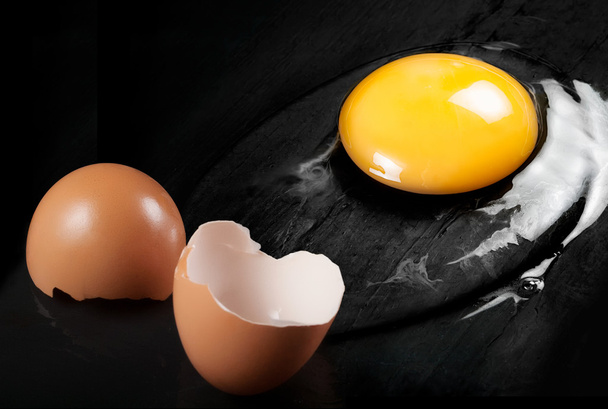 Raw Egg with Shell on Black Shale - Foto, imagen