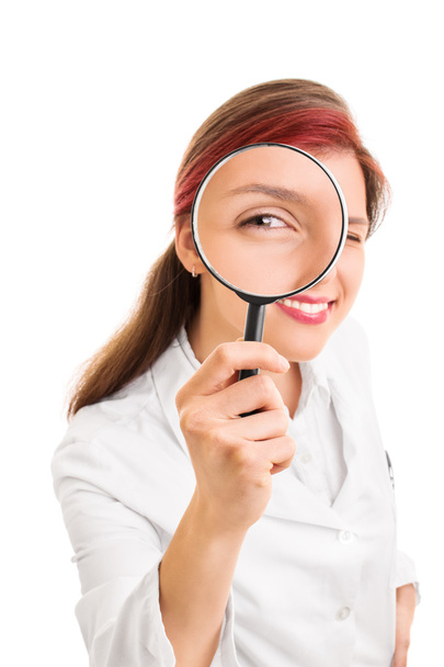 Young doctor looking through a magnifying glass - Foto, imagen