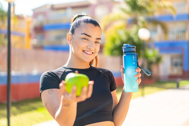 woman with apple and water at outdoors - Photo, Image
