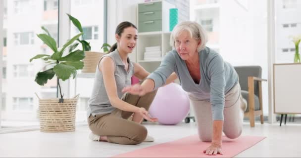 Physical therapy, healthcare and senior woman doing a exercise for wellness or recovery at a clinic. Medical, stretching and physiotherapist helping an elderly female patient at rehabilitation center. - Video, Çekim