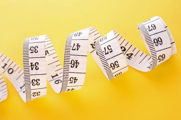 Tape Measure on yellow background - Photo, image