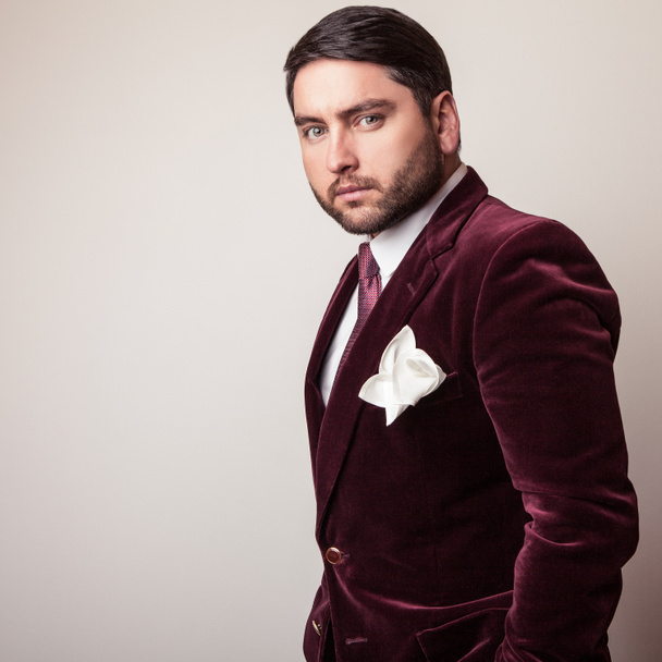 Elegant young handsome man in luxury velvet claret costume. Studio fashion portrait. - Photo, Image