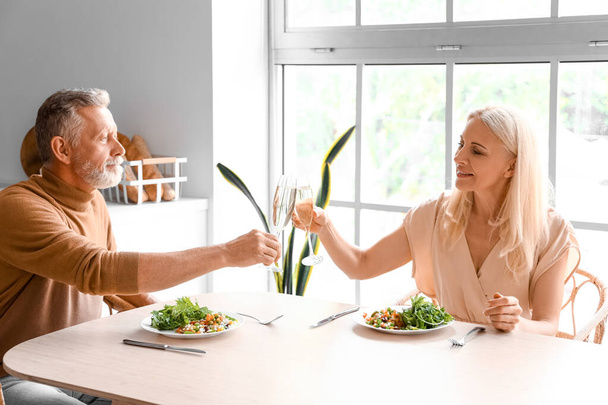 Mature couple having dinner in kitchen - Photo, Image