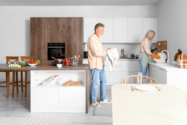 Reifes Paar spült Geschirr in Küche - Foto, Bild