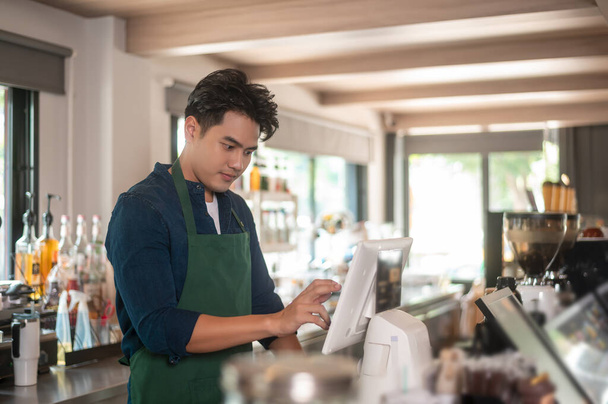 An Asian man entrepreneur or barista working in modern coffee shop , concept small business  - Fotoğraf, Görsel