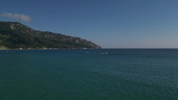 Corfu island, Greece - 2023.07.01 - 09: A small motorboat cruises through the stunning turquoise waters of the Greek islands' serene sea - Footage, Video