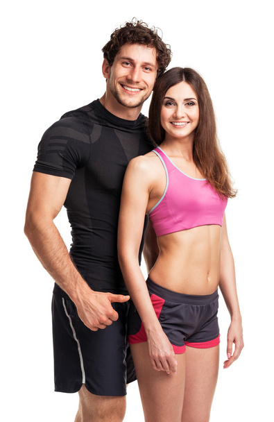 Sportpaar - Mann und Frau nach Fitnessgymnastik auf dem Weißen - Foto, Bild