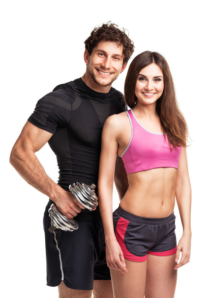 Αθλητισμός ζευγάρι - άνδρας και γυναίκα με αλτήρες στο λευκό - Φωτογραφία, εικόνα