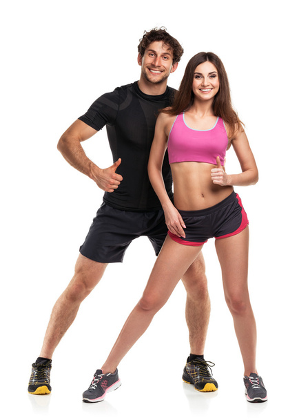 Couple athlétique - homme et femme avec le pouce sur le blanc
 - Photo, image