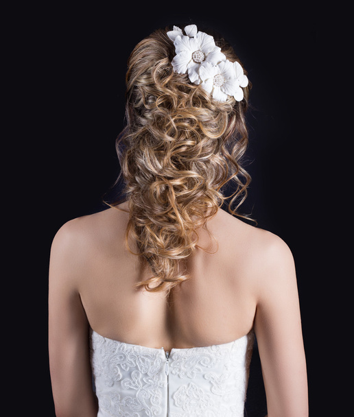 Beautiful young girl in the image of the bride, beautiful wedding hairstyle with flowers in her hair, hairstyle for bride - Valokuva, kuva