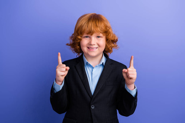 Portrait of positive funky small boy toothy smile direct fingers up empty space ad isolated on purple color background. - Valokuva, kuva