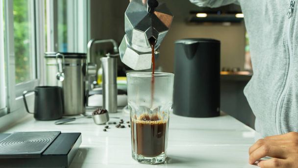 personas que utilizan italiano clásico Moka café olla verter, cafetera con equipo herramienta de elaboración de barra de mármol en la cocina casera - Foto, imagen