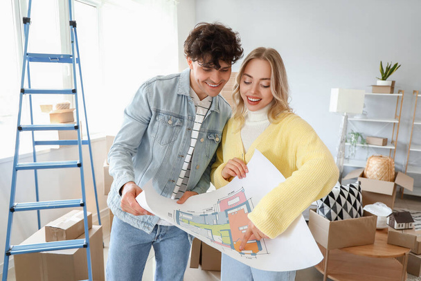 Young couple with house plan in bedroom on moving day - Photo, Image
