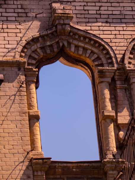 Fragment of the facade of an old building with arched red brick windows. - Photo, Image