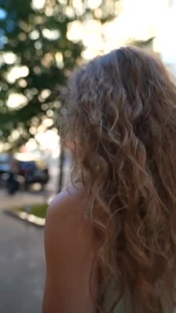 curly girl is going to a car guard. High quality 4k footage - Footage, Video