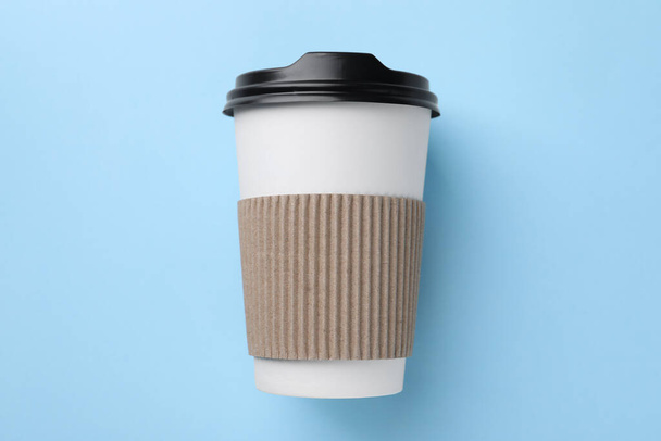 One paper cup on light blue background, top view. Coffee to go - Photo, image
